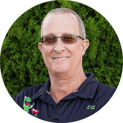Eco-friendly lawn care professional operating Ecolawn organic spreading equipment outdoors.